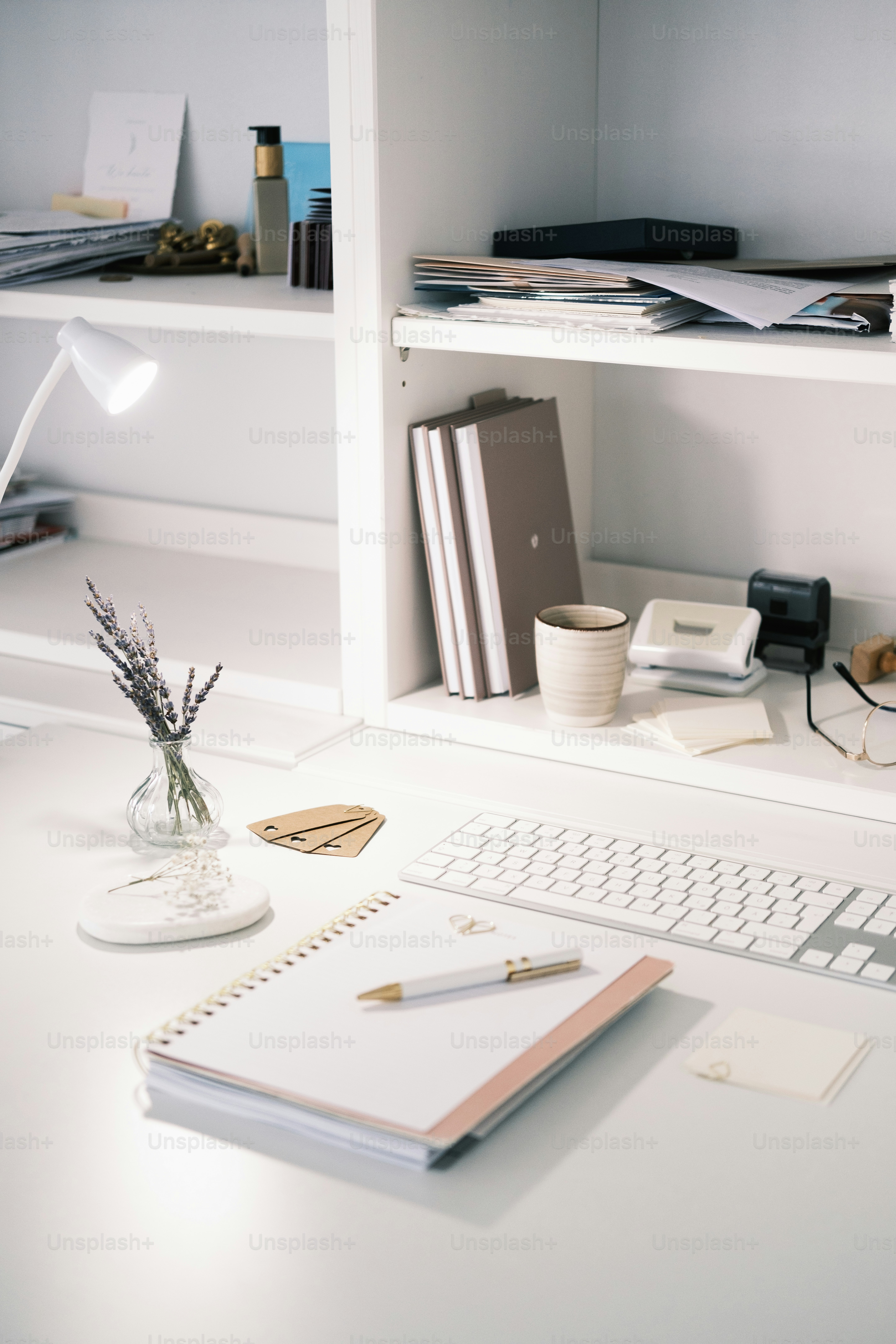a white desk with a keyboard and a monitor