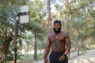 a man with no shirt on holding a basketball