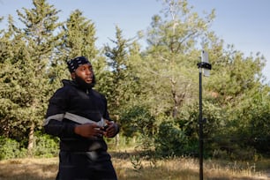 a man in a black jacket holding a frisbee