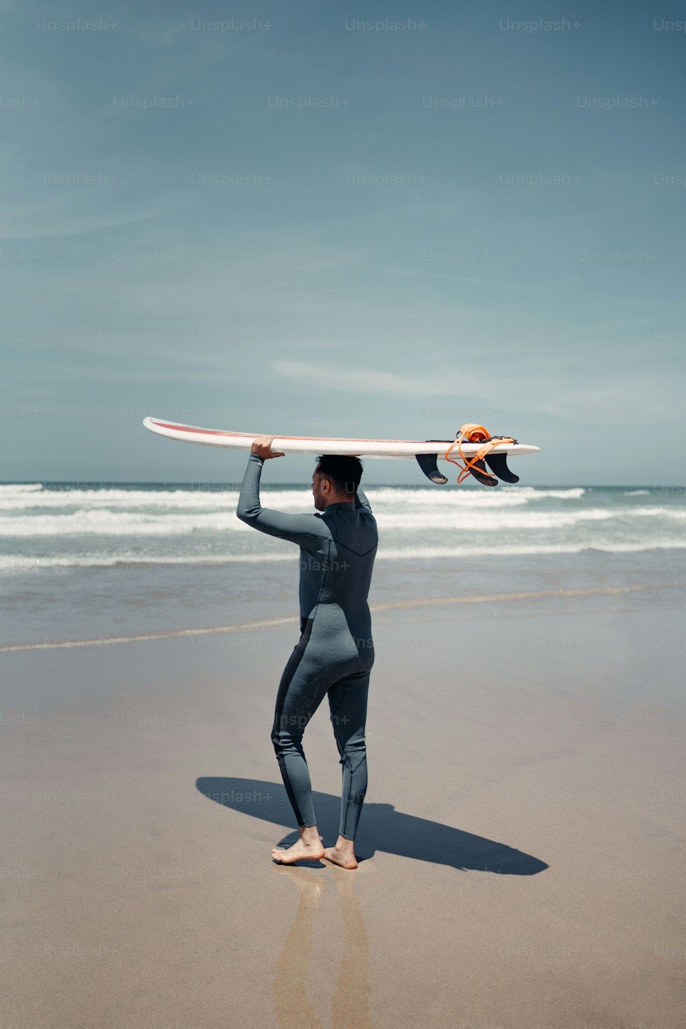 a man holding a surfboard on top of his head