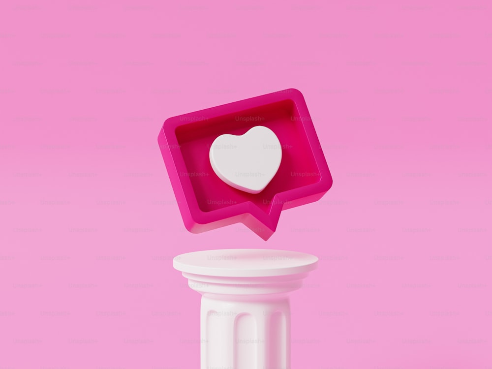 Un objeto rosa con un corazón blanco en una burbuja de diálogo