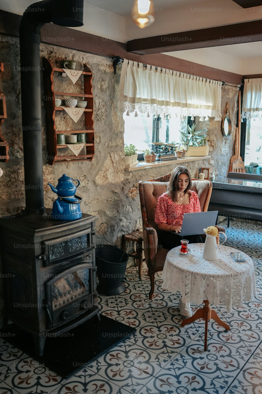 a woman sitting in a chair in front of a laptop computer