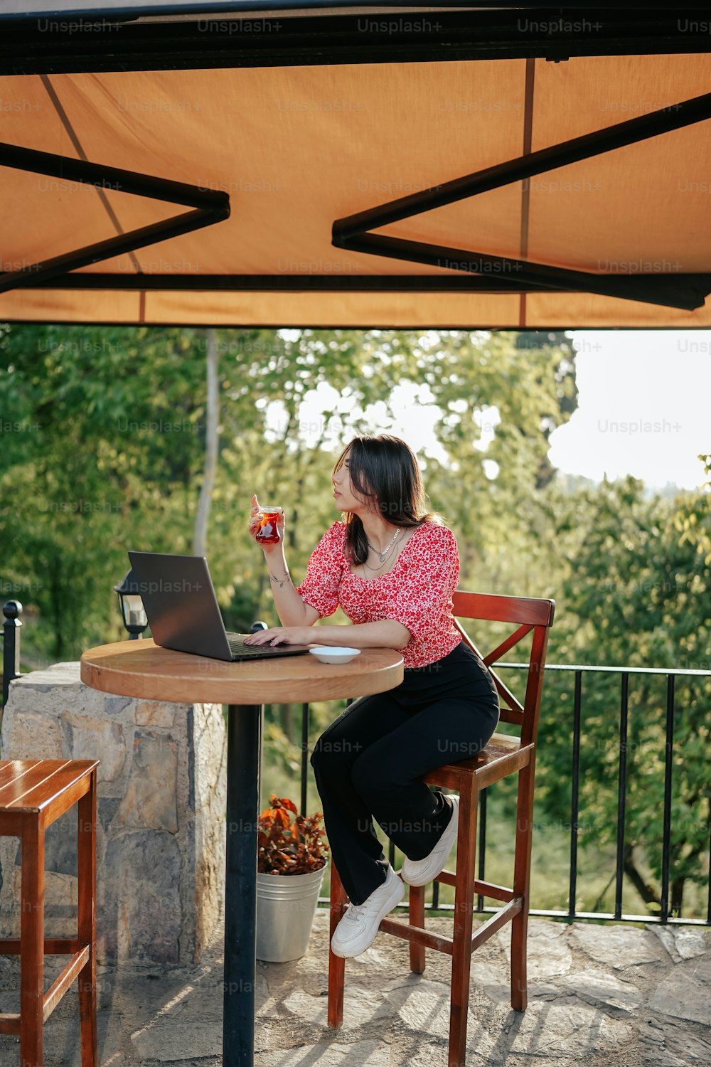 a woman sitting at a table with a laptop