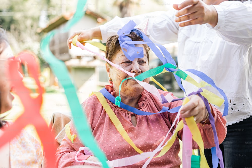 a woman in a wheel chair with streamers around her
