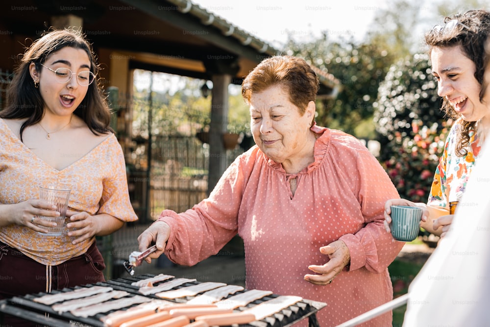 a group of people standing around a grill