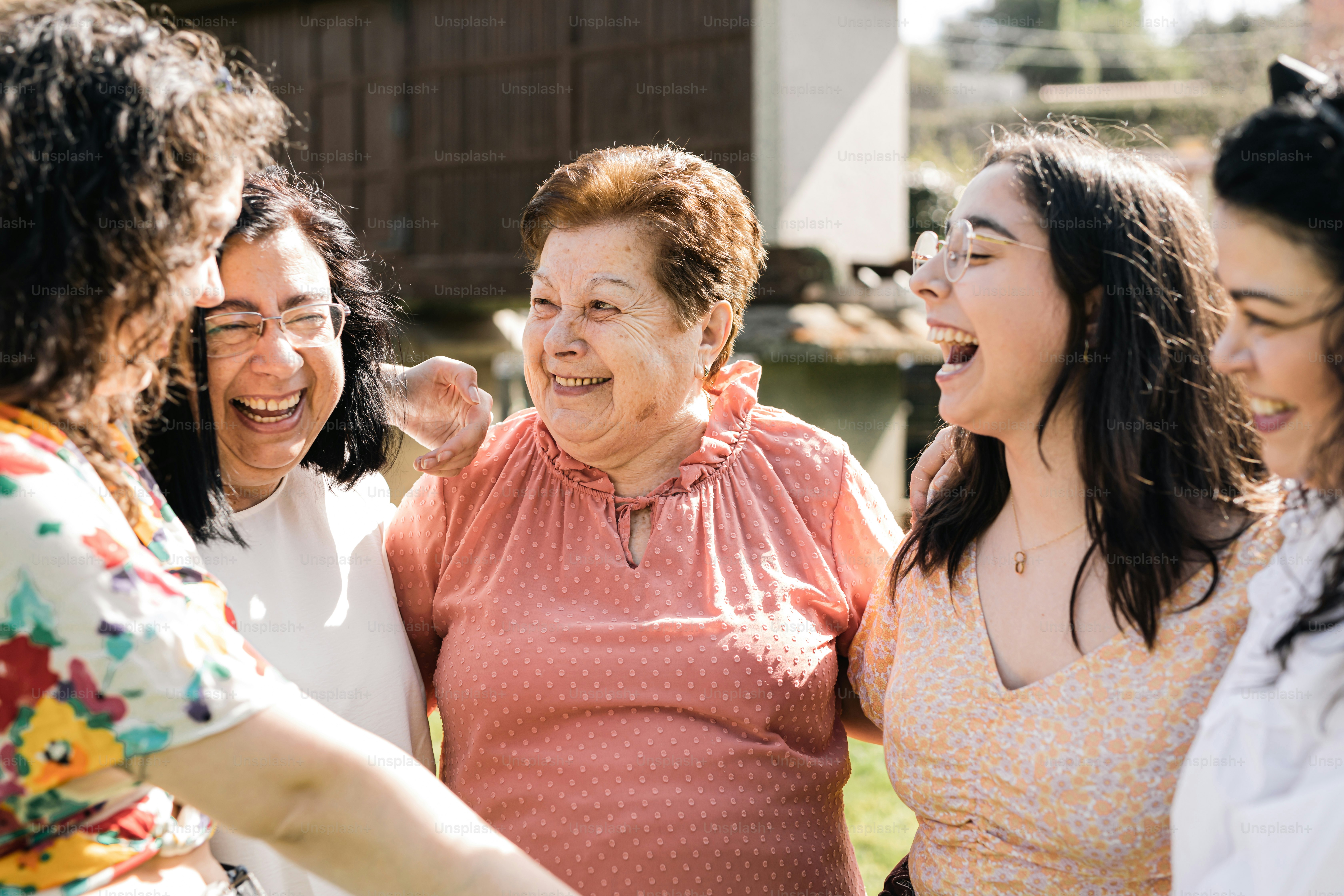 A group of women standing next to each other photo – Happy Image on ...