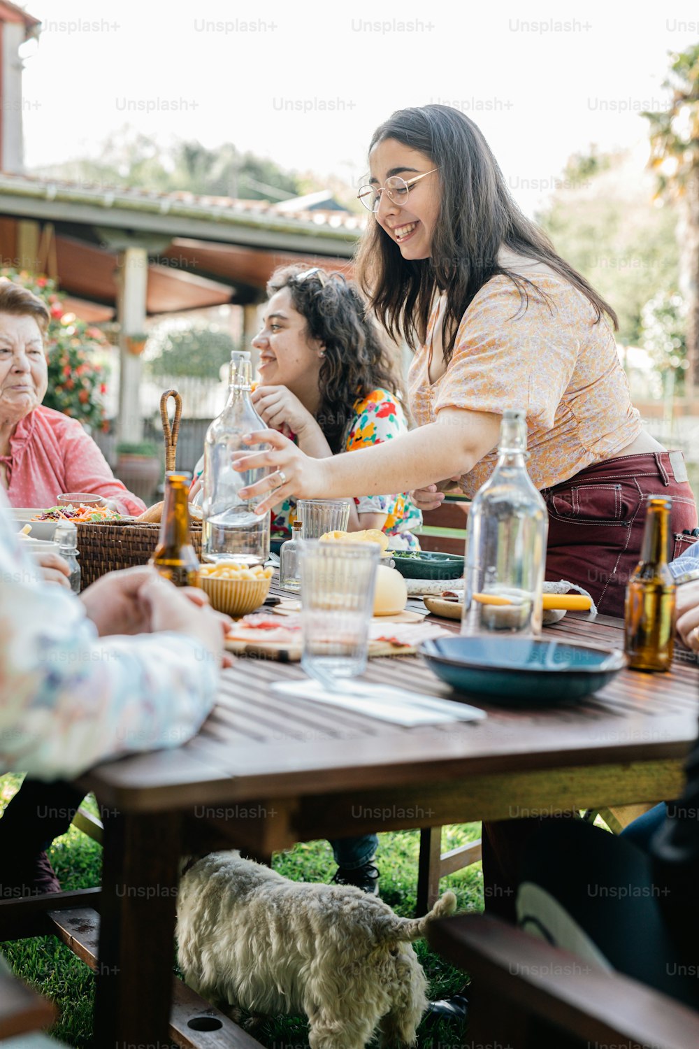 a group of people sitting around a wooden table