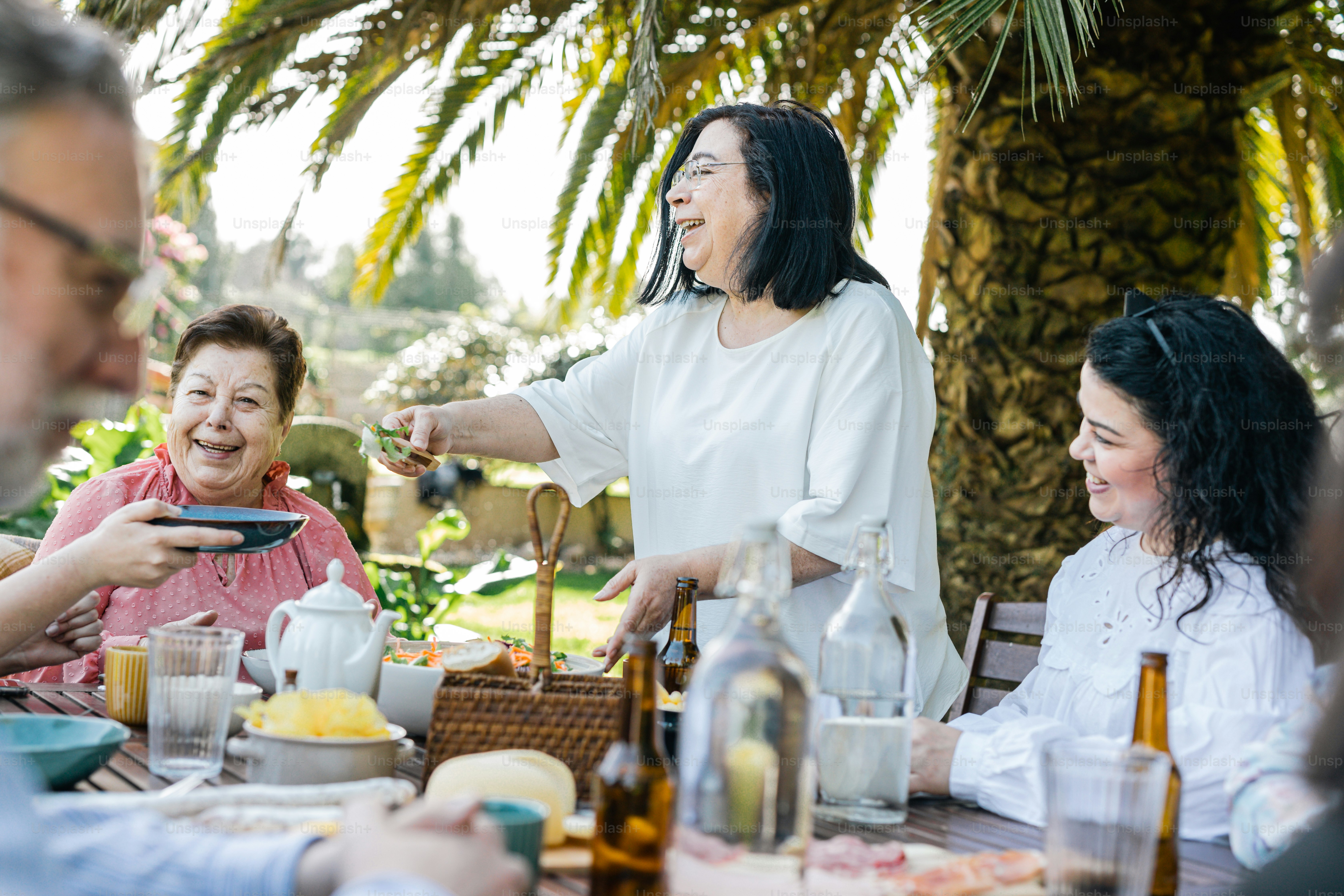 a group of people sitting around a table eating food