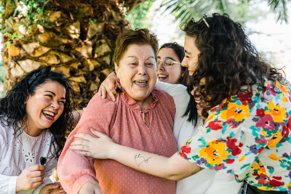 a group of women hugging each other outside