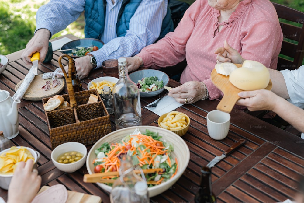 a group of people sitting around a table eating food