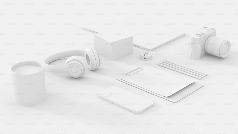 um conjunto de objetos brancos, incluindo uma câmera, fones de ouvido e notebooks