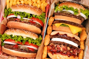 two trays filled with hamburgers and french fries