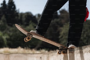 a person riding a skateboard on top of a cement wall