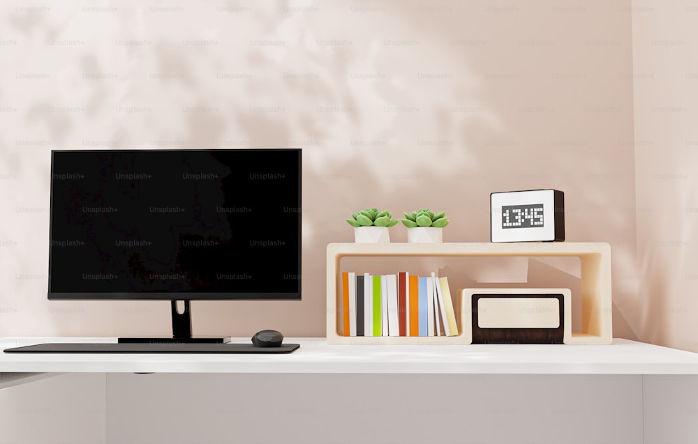 하얀 책상 위에 놓인 평면 스크린 TV