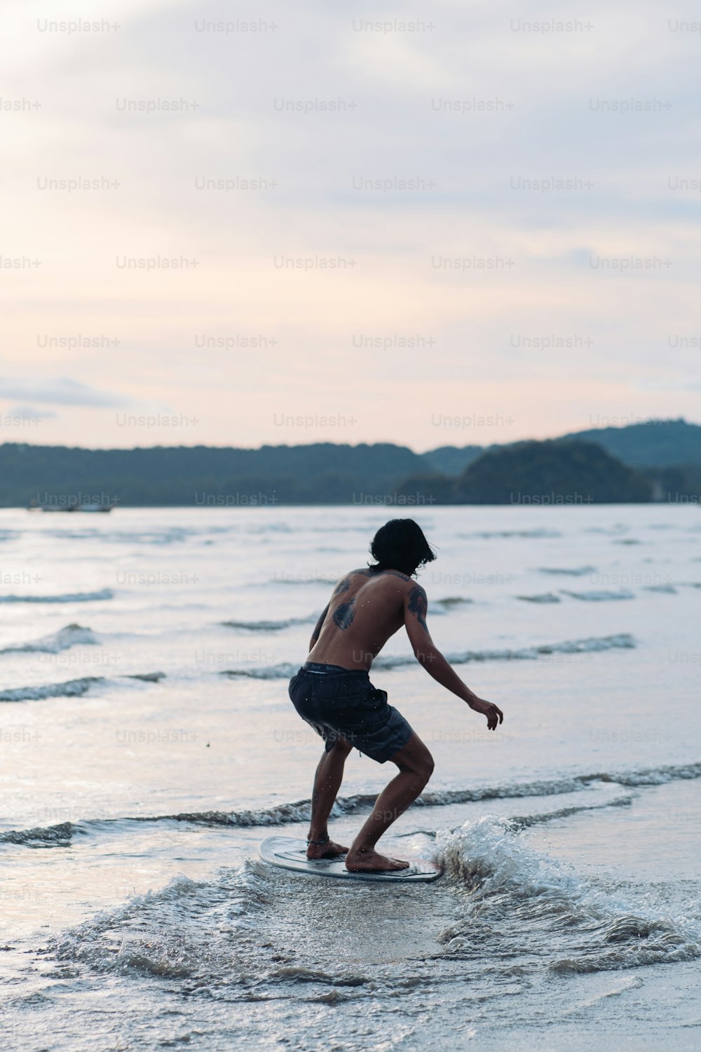 a man riding a wave on top of a surfboard