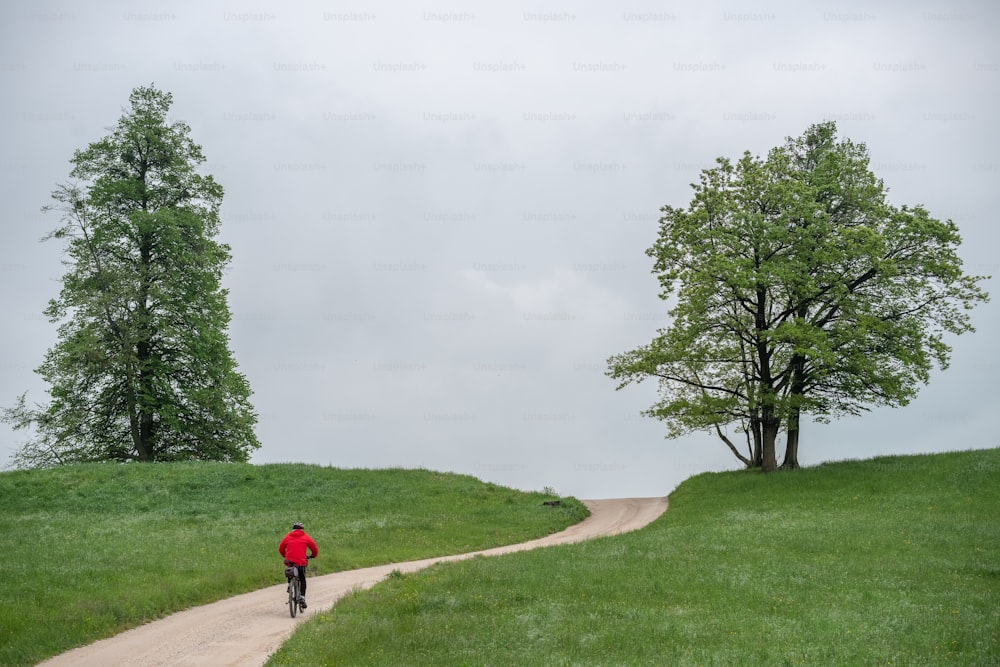 a person riding a bike down a dirt road