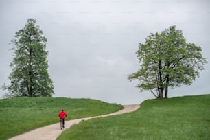 a person riding a bike down a dirt road