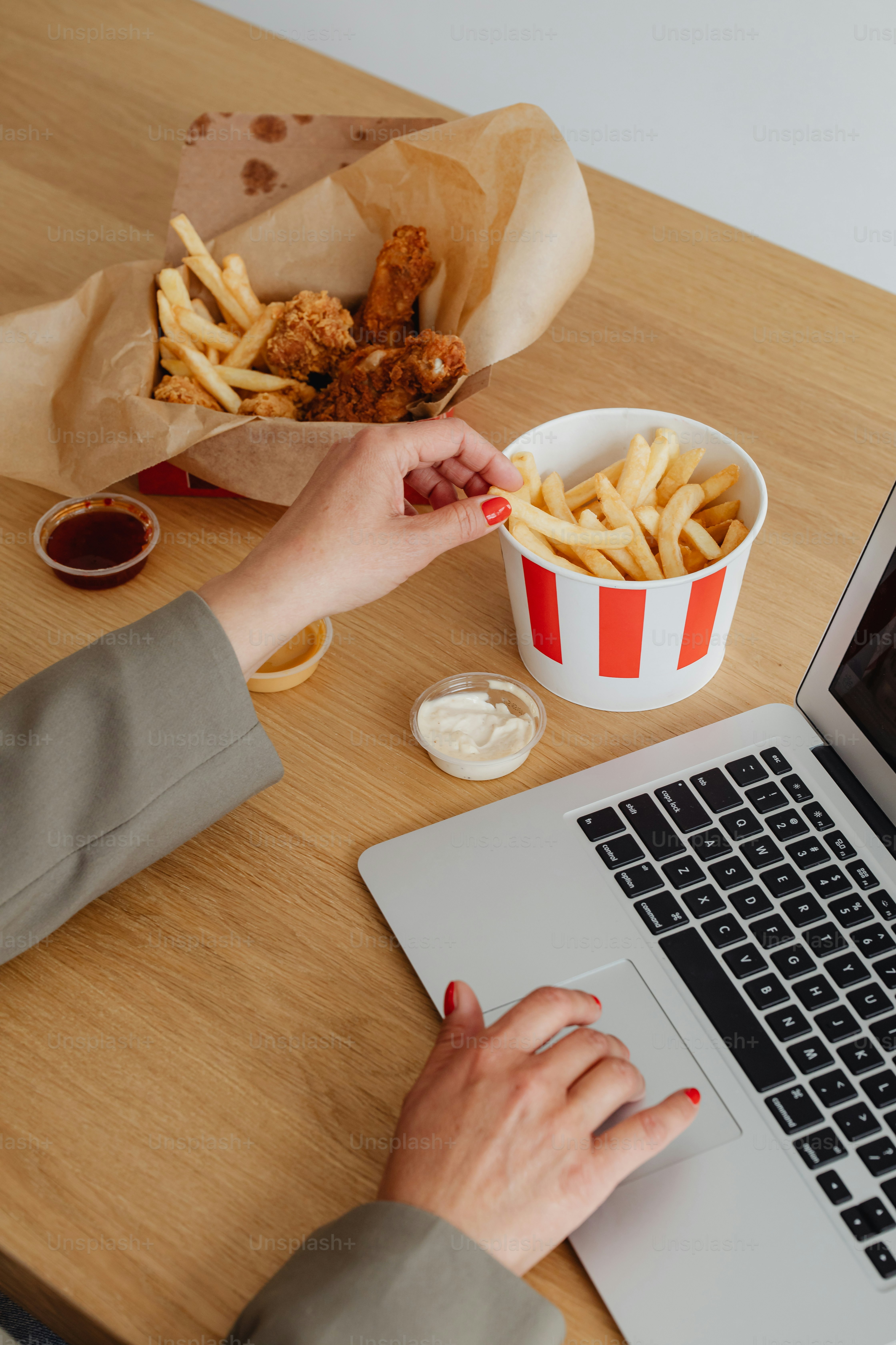 a person using a laptop on a wooden table