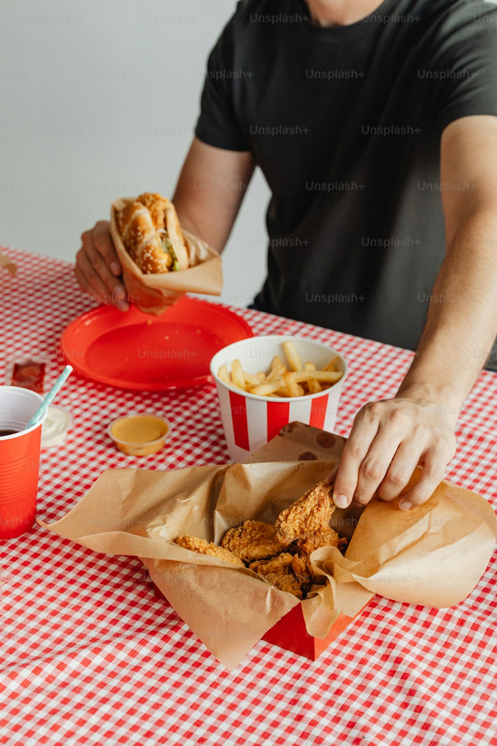 a man sitting at a table with a basket of food