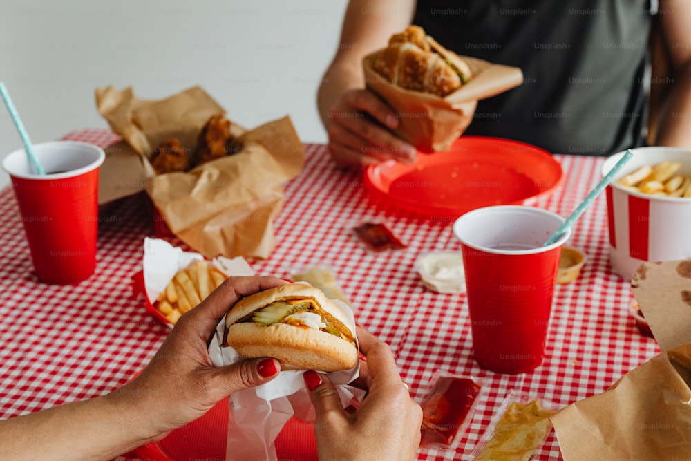 a person eating a hot dog at a picnic table