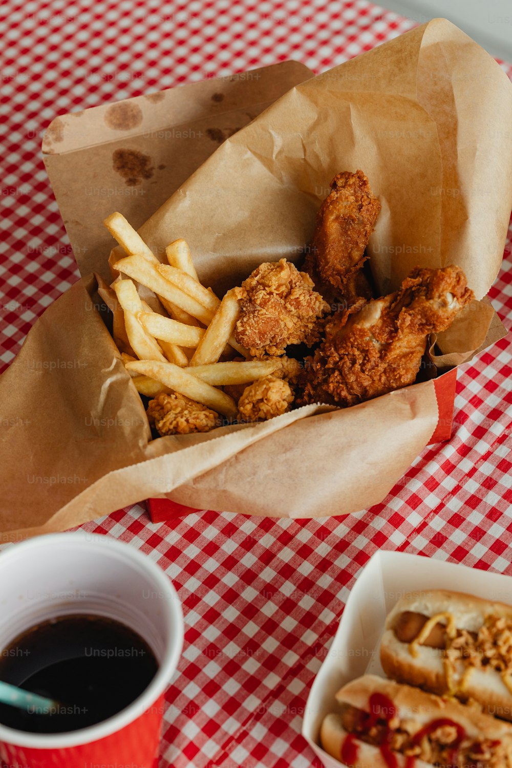 a basket of fried food next to a cup of coffee