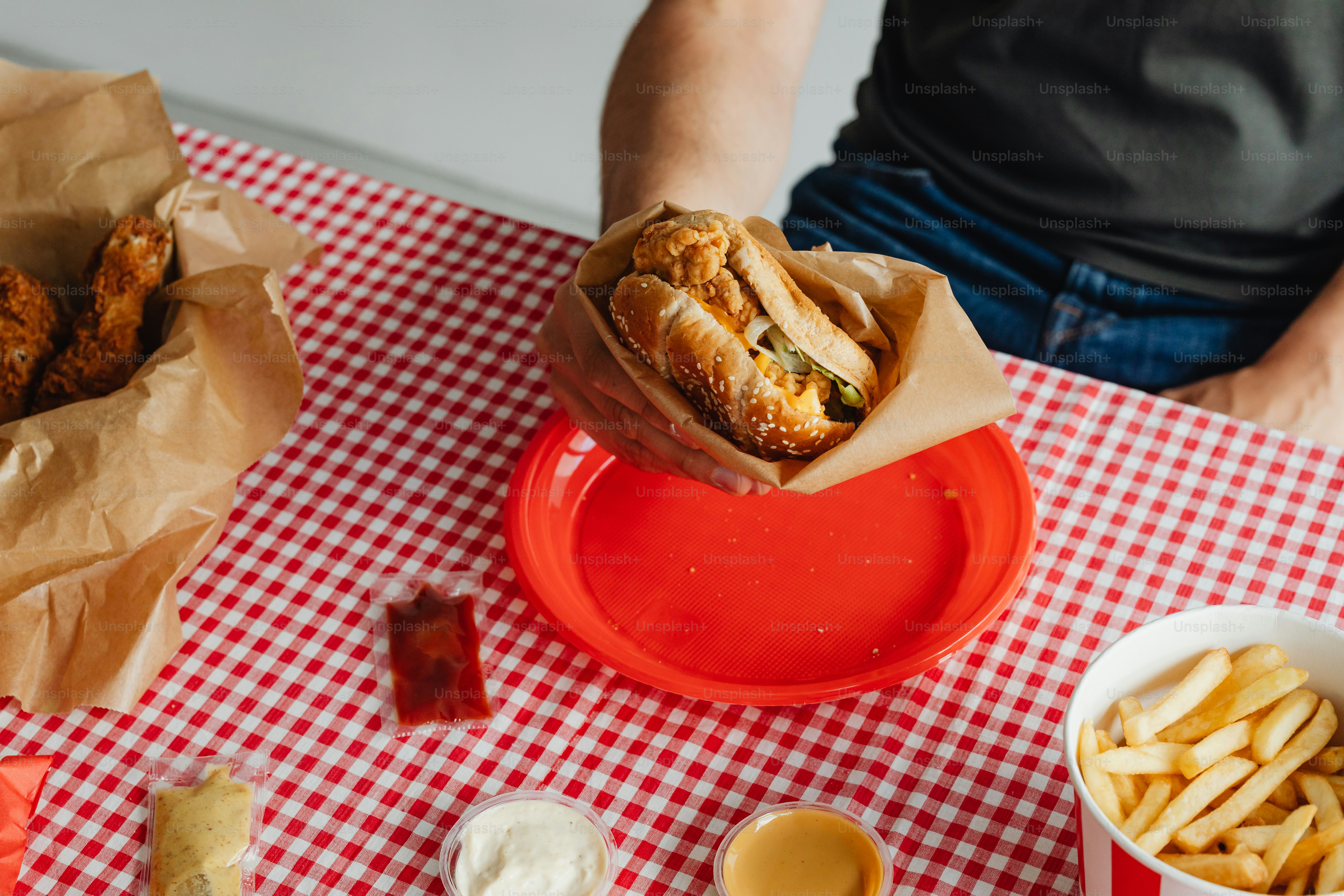 a person sitting at a table with a basket of food