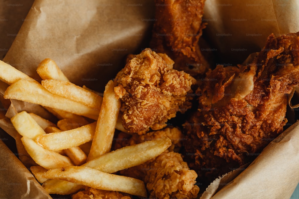 a basket filled with fried chicken and french fries