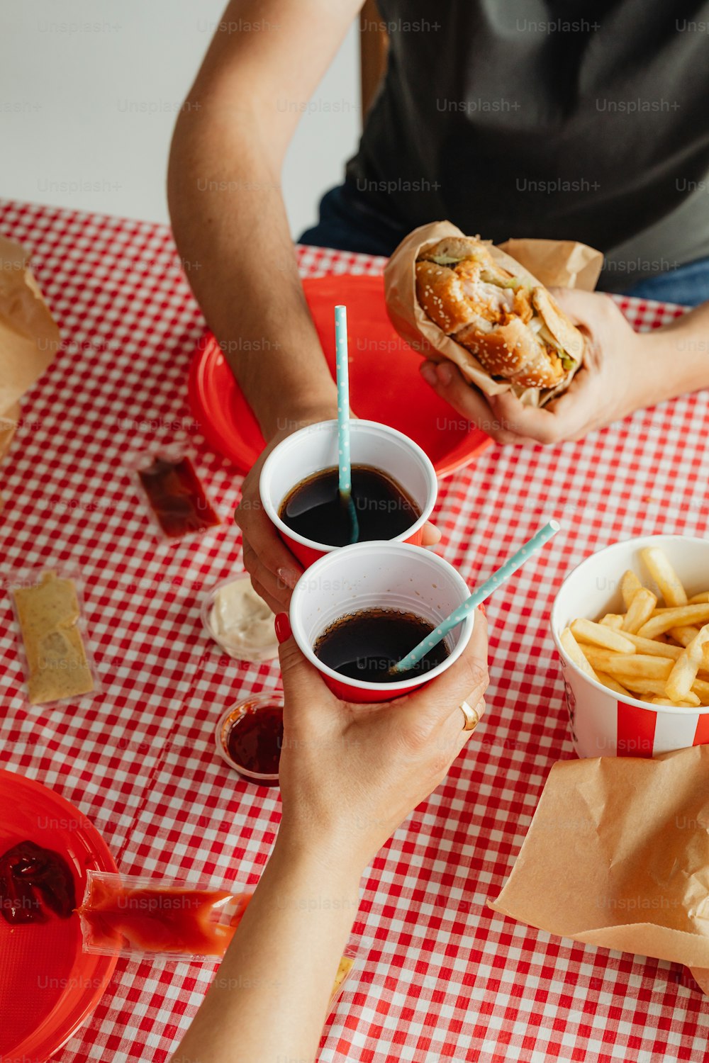 a couple of people sitting at a table with some food