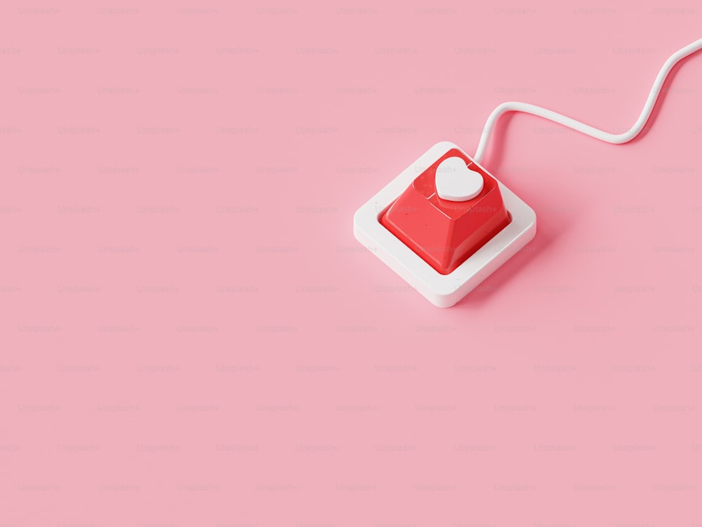 a red and white light switch on a pink background
