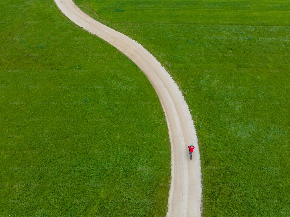 a person riding a bike down a dirt road