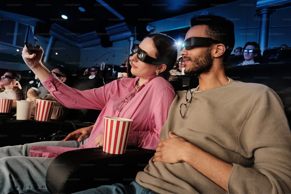 a man and a woman sitting in a movie theater