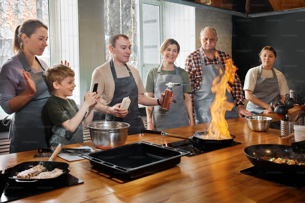 a group of people standing around a wooden table