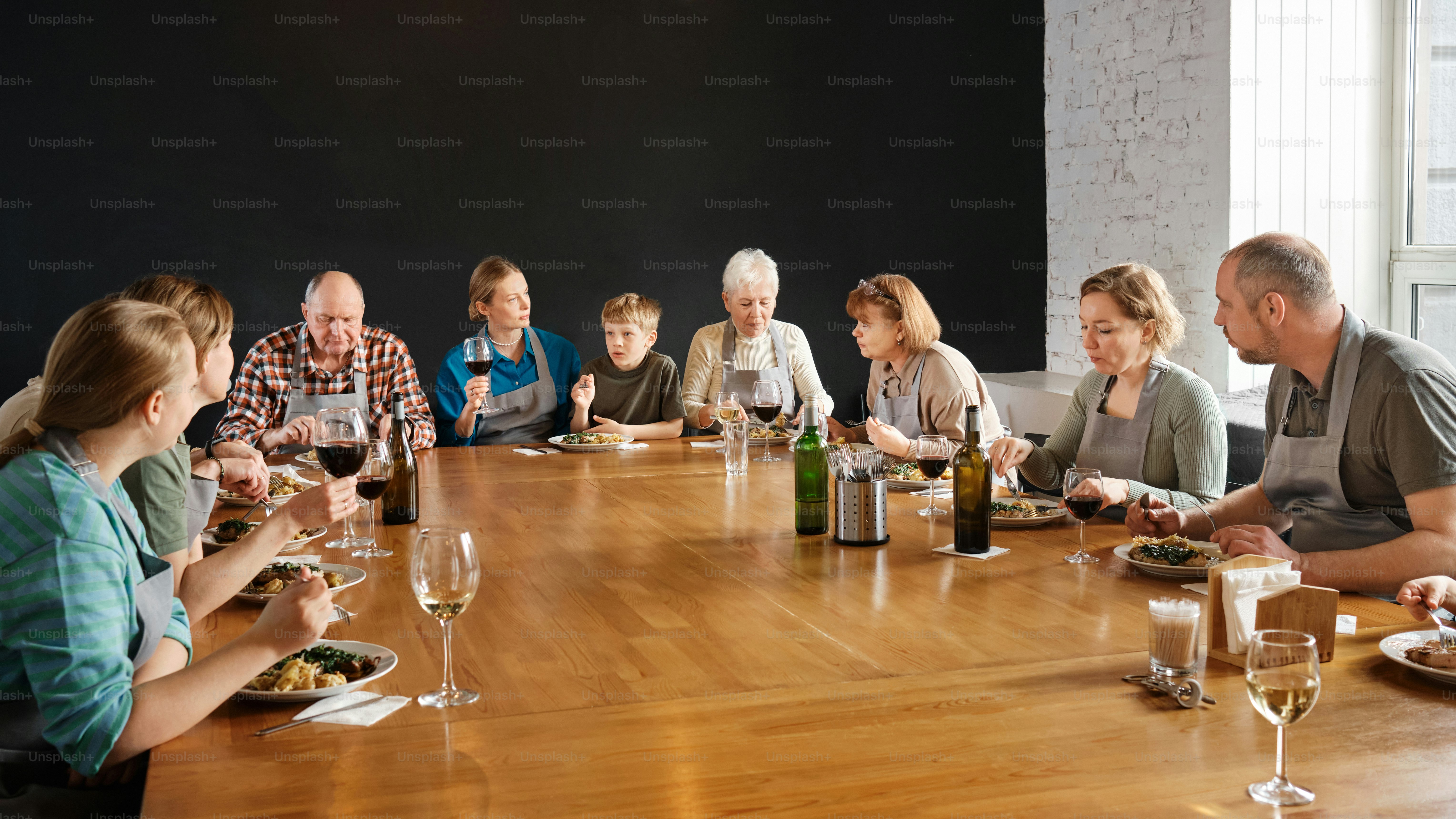 a group of people sitting around a wooden table