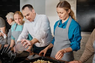 a group of people preparing food in a kitchen