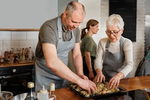 a couple of people that are standing in a kitchen