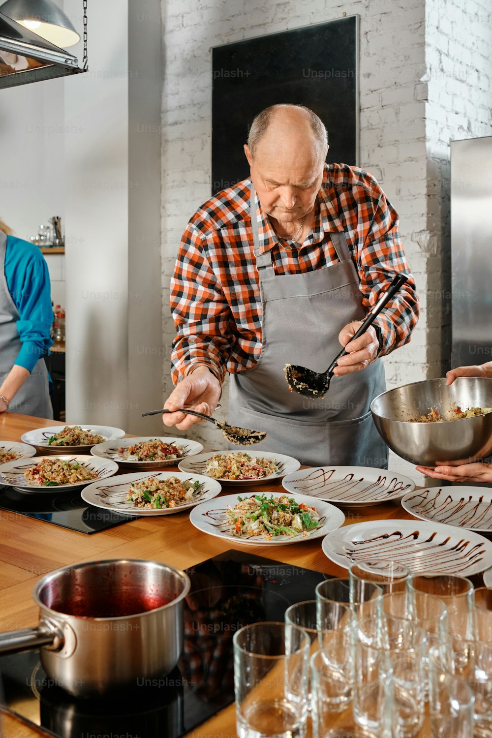 a man in an apron preparing food in a kitchen