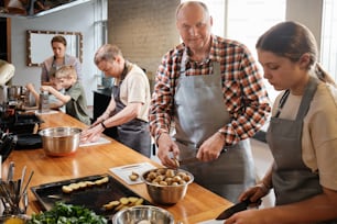 a group of people in a kitchen preparing food