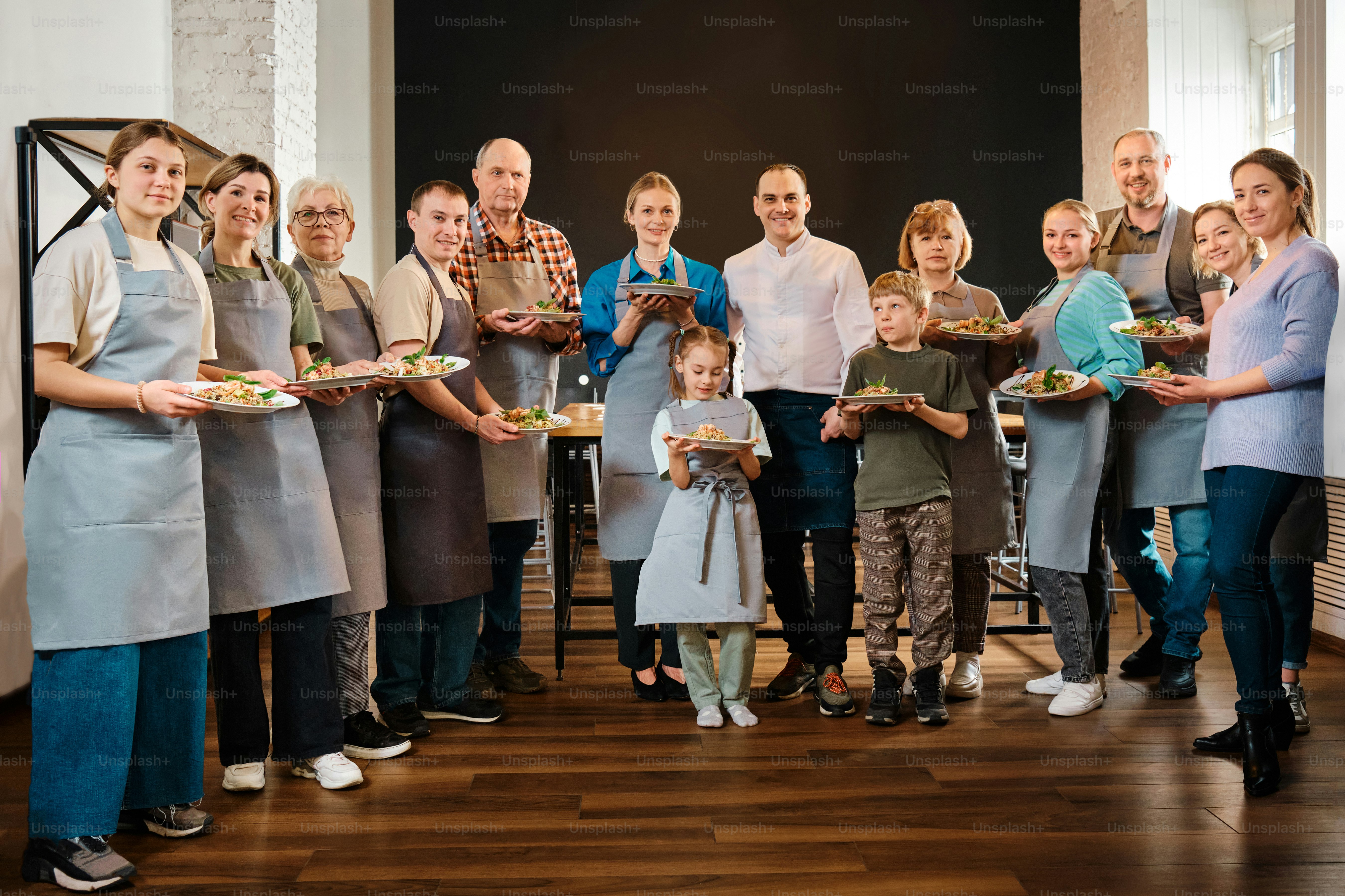 a group of people holding plates of food
