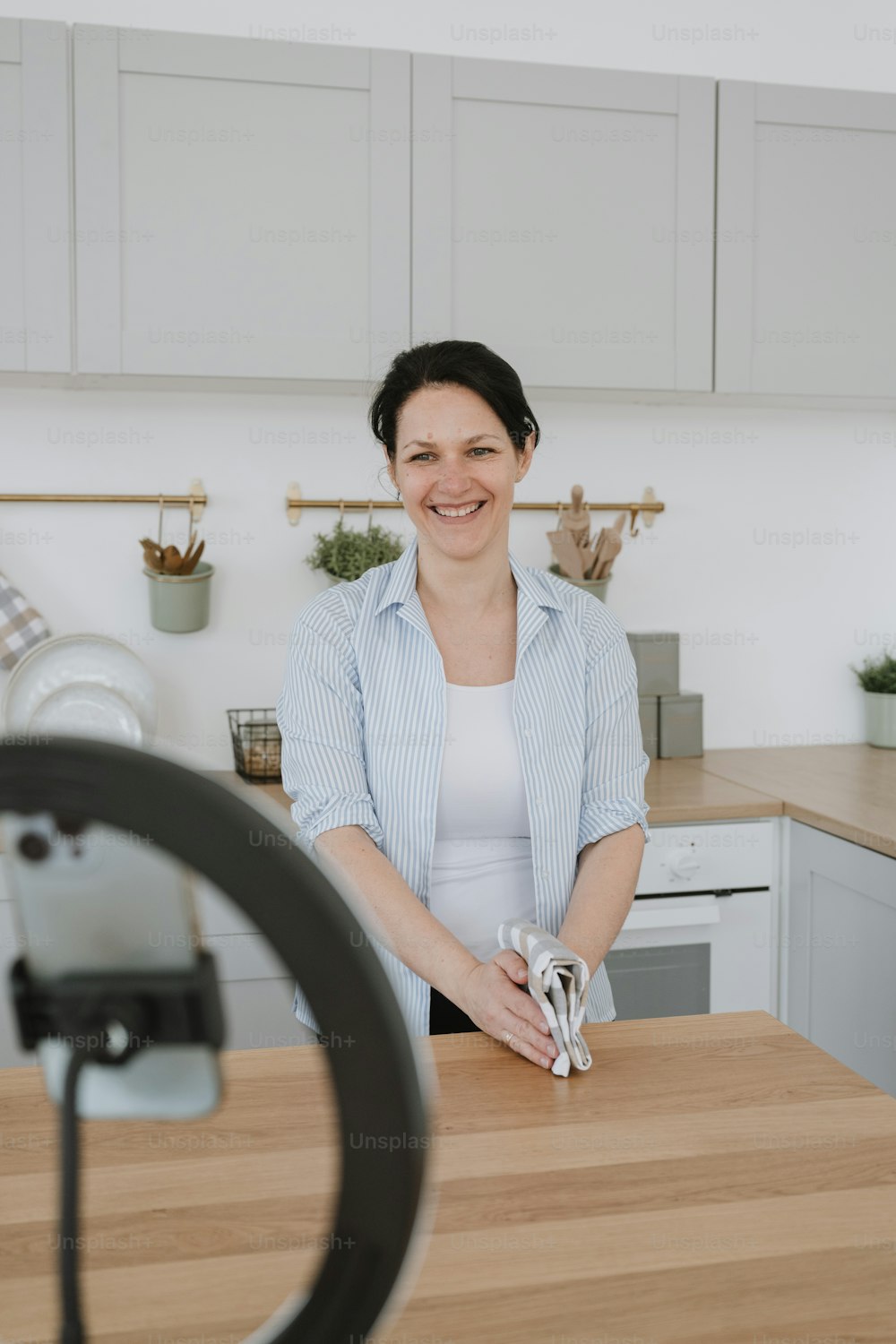 a woman standing at a counter in a kitchen