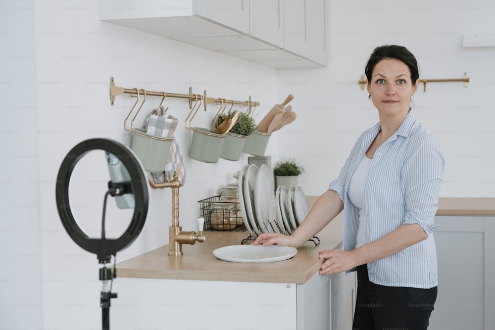 a woman standing in a kitchen next to a counter
