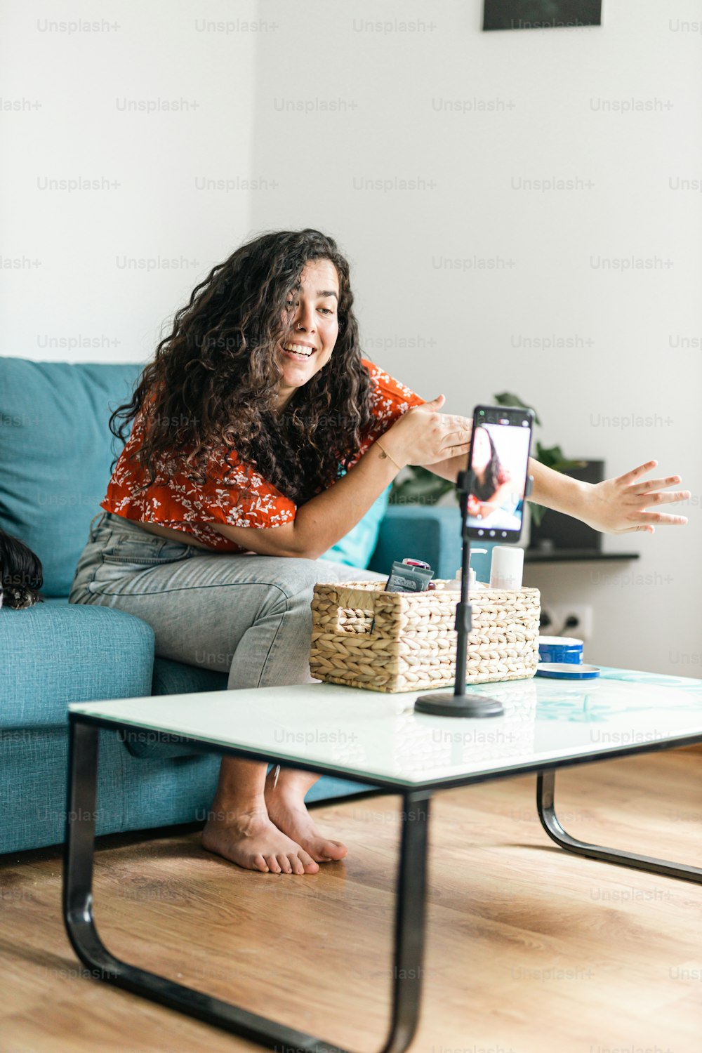 a woman sitting on a couch with a remote control