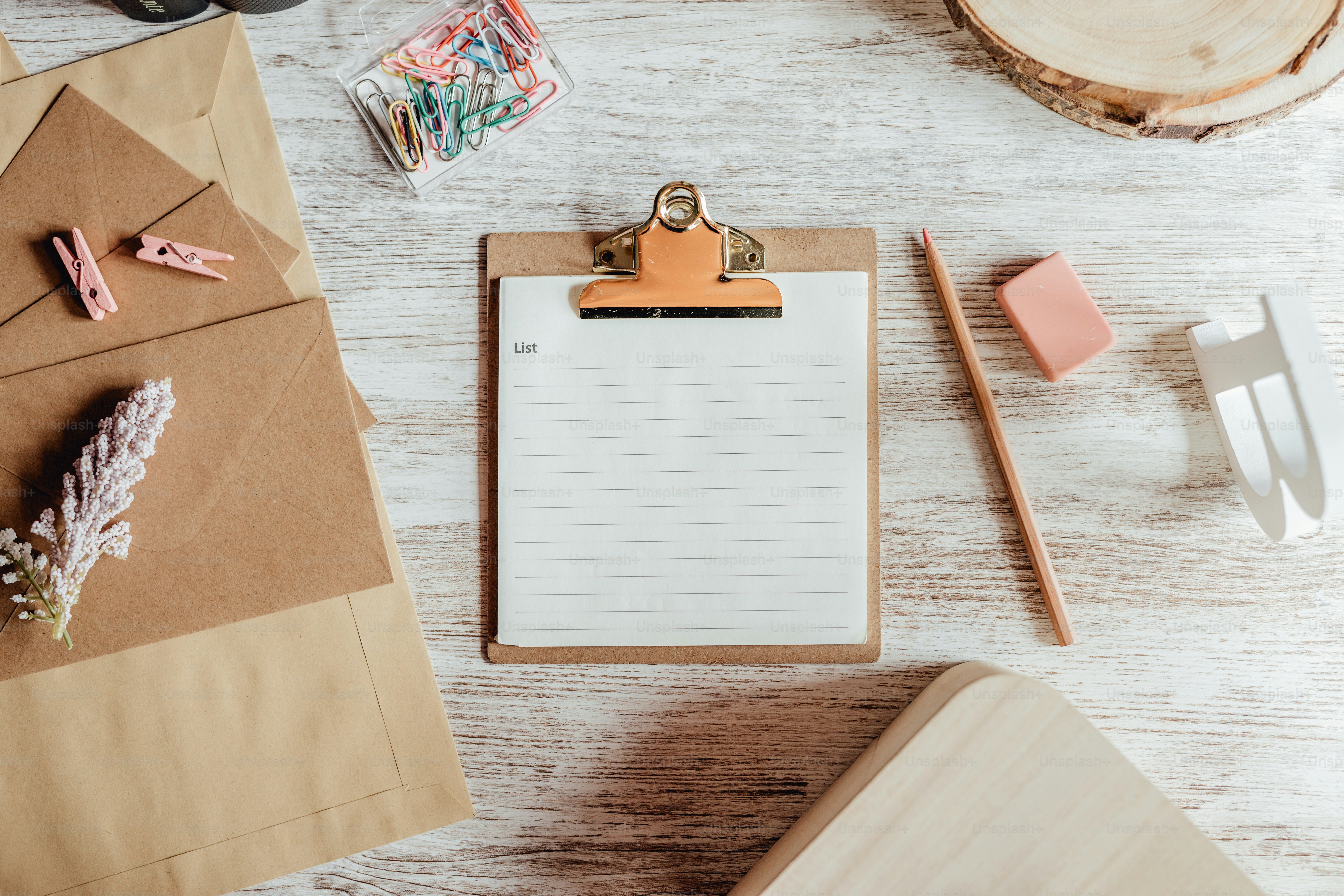 a clipboard with a notepad on it next to a pair of scissors and