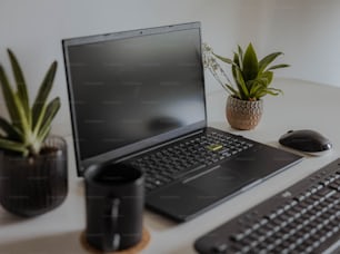 a laptop computer sitting on top of a white desk