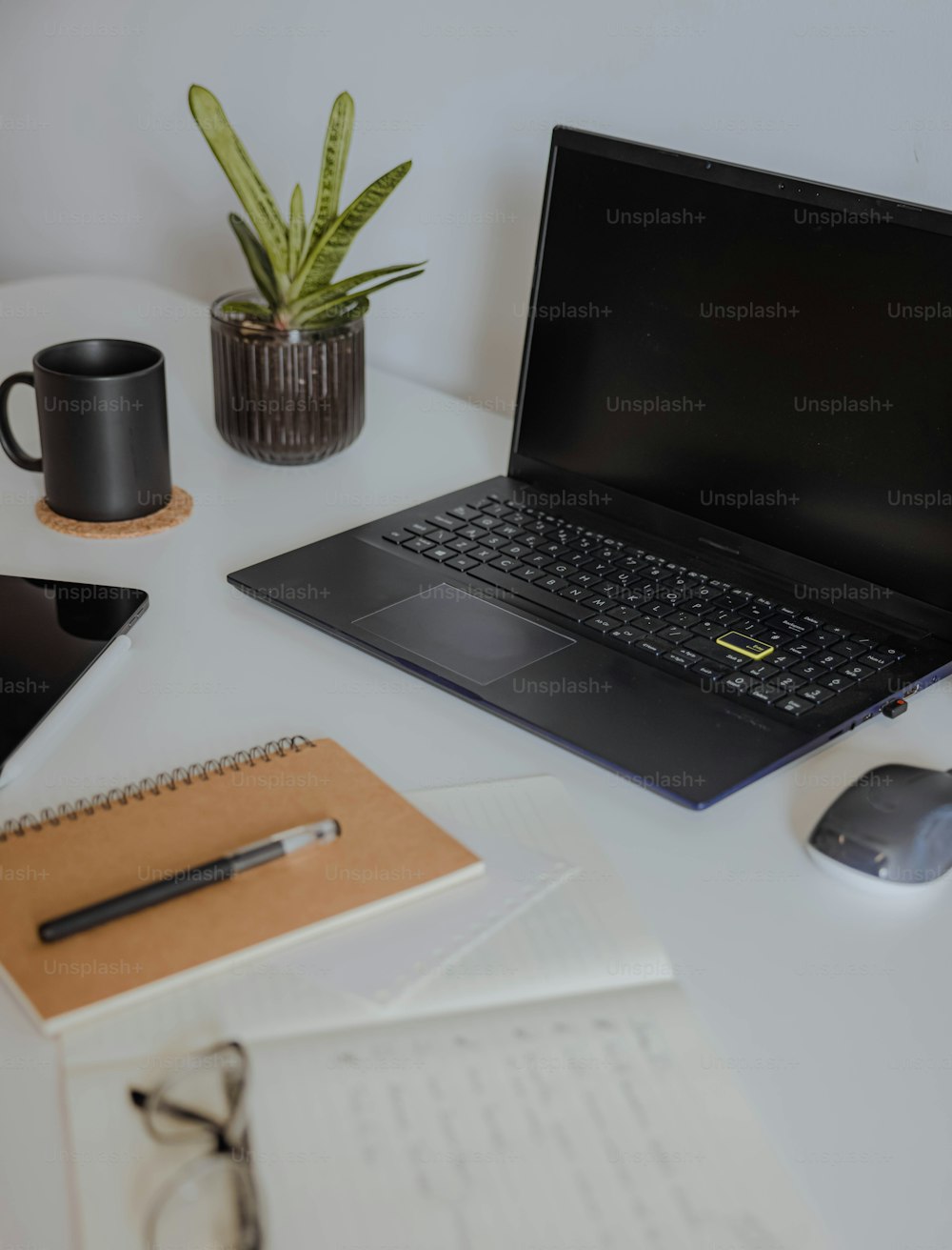 a laptop computer sitting on top of a white desk