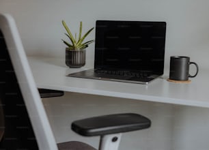 a laptop computer sitting on top of a white desk