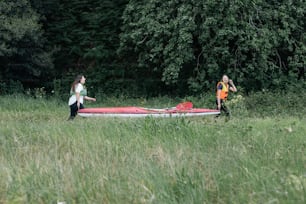 a couple of women walking across a lush green field