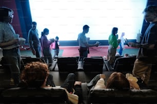 a group of people standing in front of a projection screen