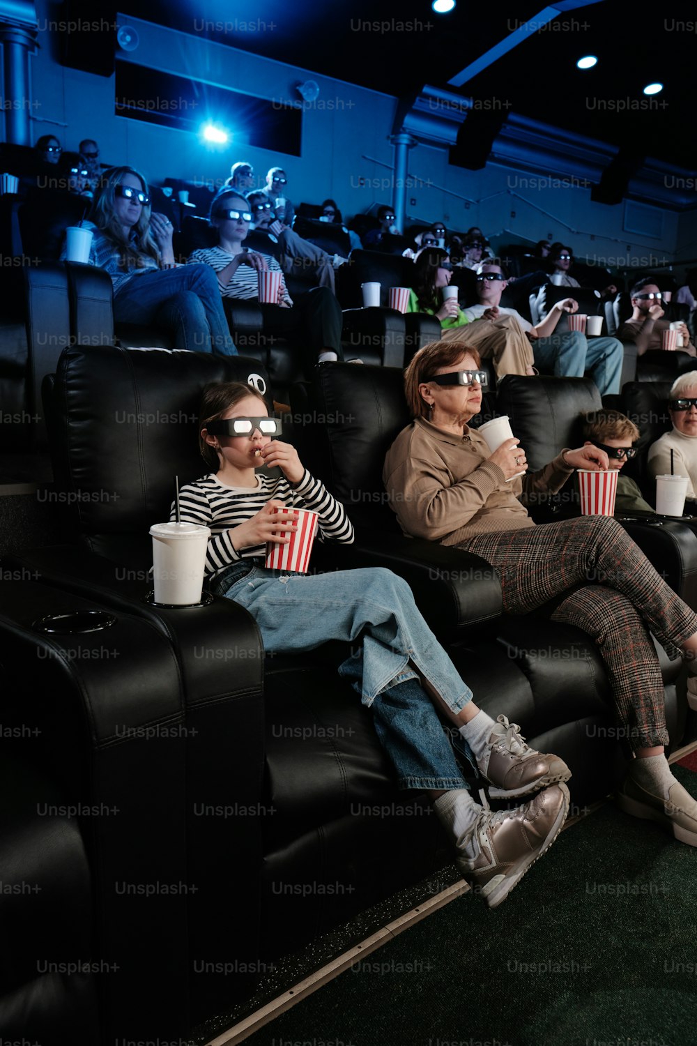 a group of people sitting in a movie theater