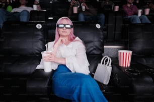 a woman with pink hair wearing 3d glasses