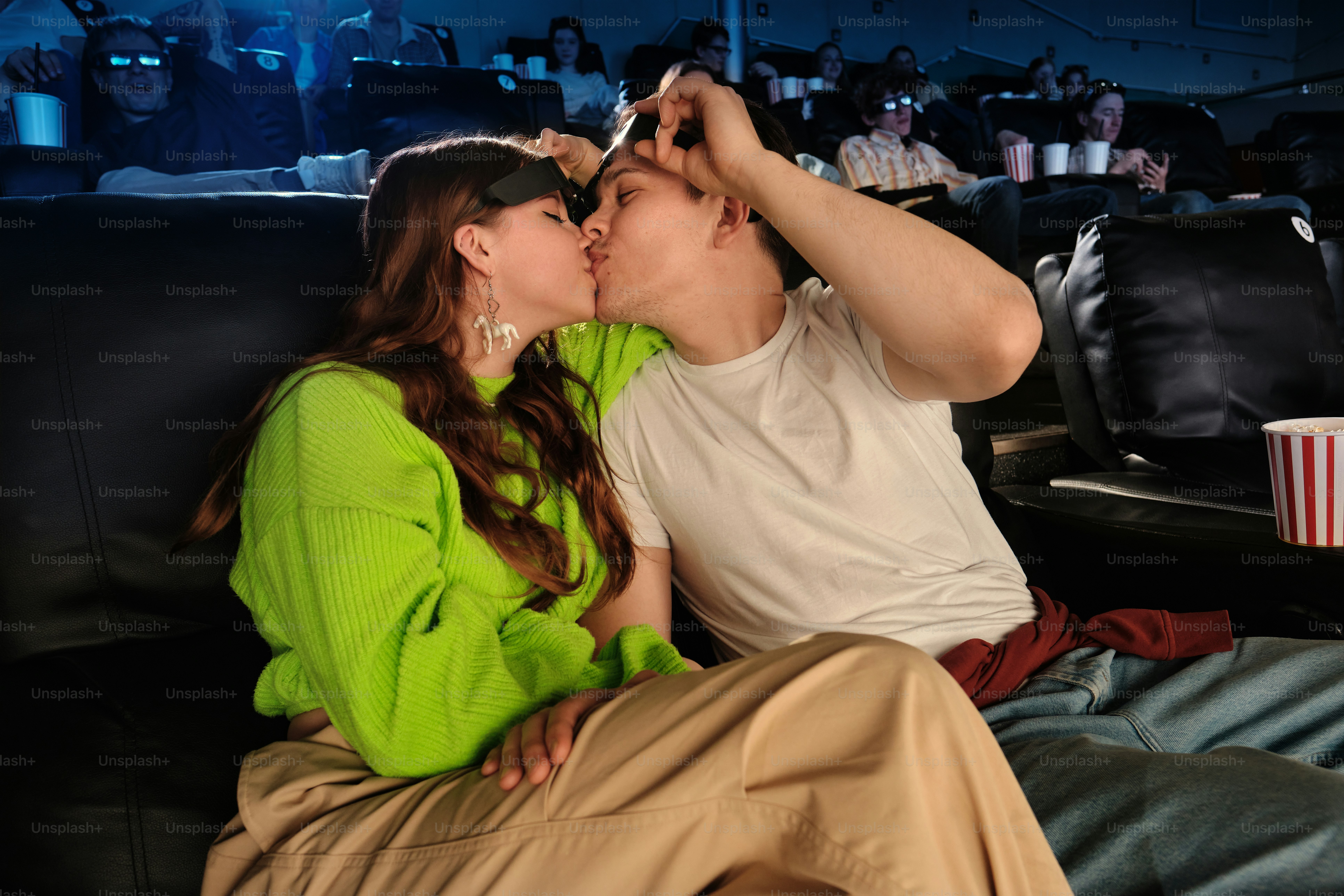 a couple kissing in a movie theatre
